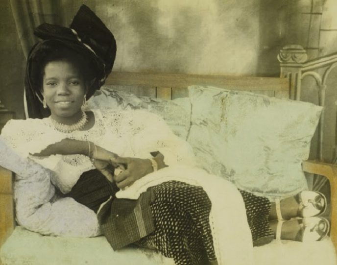 Reclining young ladyHand-colored photograph by Chief S.O. Alonge, c. 1950Benin City, NigeriaChief Solomon Osagie Alonge CollectionEEPA 2009-007National Museum of African ArtSmithsonian Institution