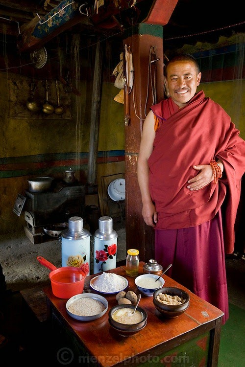 The head monk at his partially rebuilt monastery with his typical day’s worth of food in the Tibetan Plateau. (From the book What I Eat: Around the World in 80 Diets.) The caloric value of his day's worth of food in June was 4,900 kcals. He is 45 years of age; 5 feet, 5 inches tall; and 158 pounds.